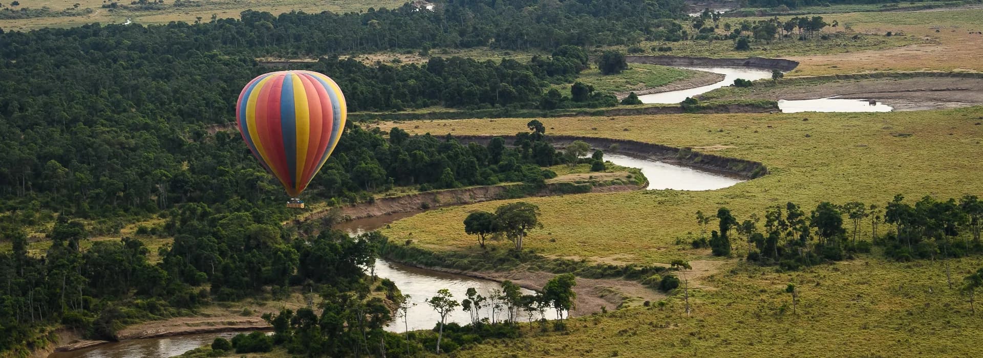 Hot-air balloon floating above the winding Mara River