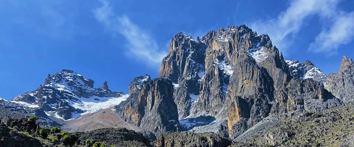 Jagged peaks of Mount Kenya under a clear blue sky