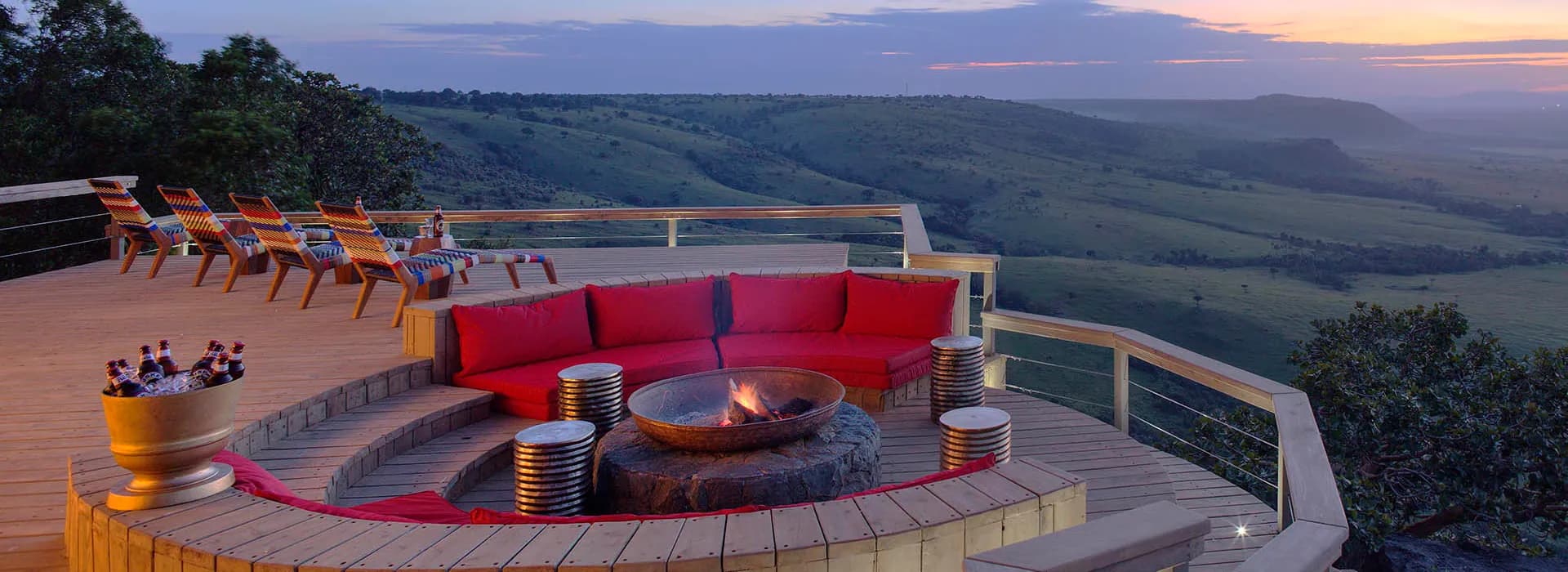 Lodge deck with a firepit overlooking the valley at dusk