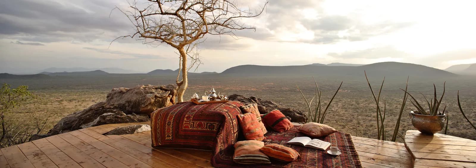 Cushioned lounge on a rock outcrop overlooking the plains